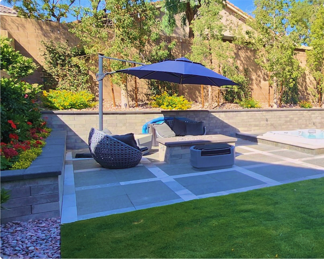 A patio with an umbrella and chairs in it A patio with an umbrella and chairs in it