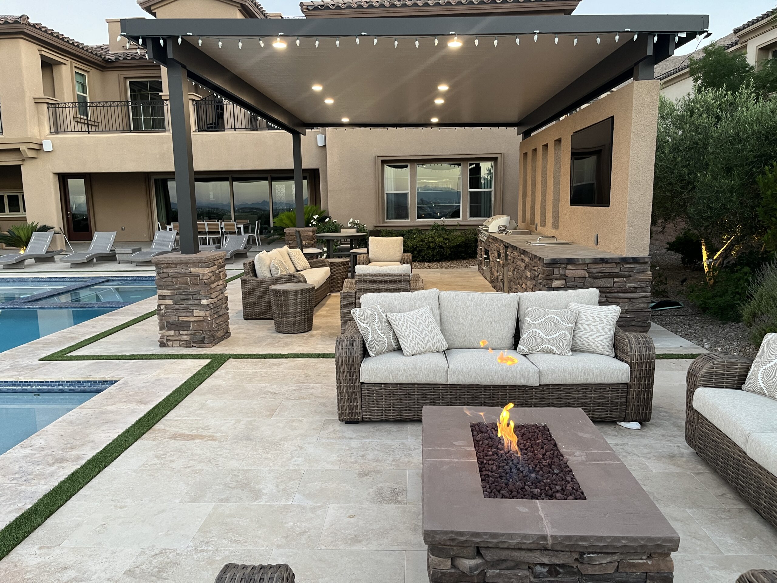 A patio with fire pit and couch in it A patio with fire pit and couch in it